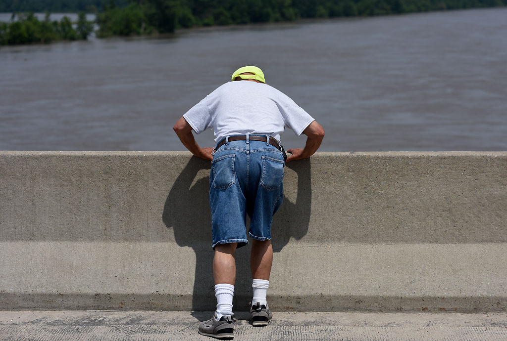 John Wilke peers over the bridge that extends across the Missouri River